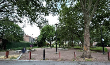 A park with trees and empty dirt space